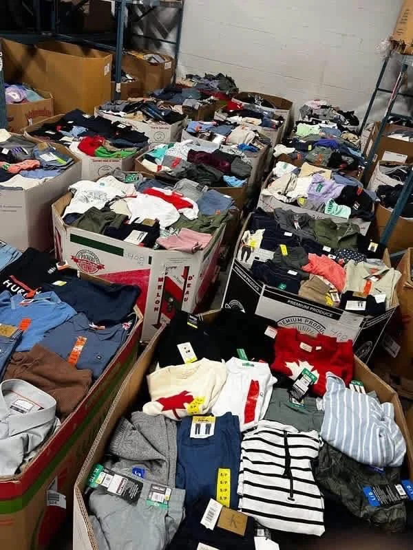 Luxury retailer apparel liquidation pallet with assorted wholesale clothing and fashion accessories