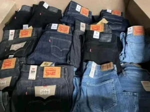 Wholesale branded jeans pallet containing approximately 300 assorted overstock denim pieces