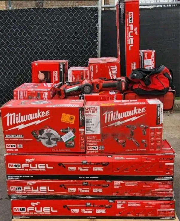 Wholesale Milwaukee tool assortment with batteries, chargers, work lights, and power-tool accessories.
