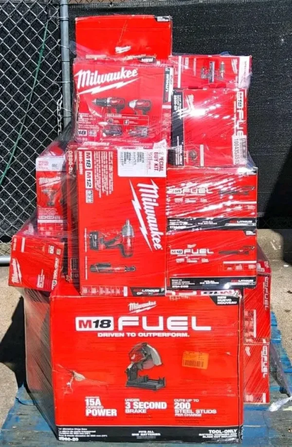 Wholesale Milwaukee tool assortment with batteries, chargers, work lights, and power-tool accessories.