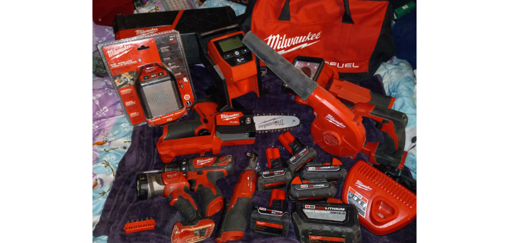 Milwaukee tool pallet featuring assorted cordless drills, impact drivers, saws, and power tools