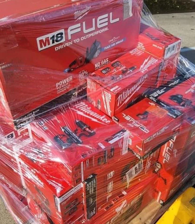 Wholesale Milwaukee tool assortment with batteries, chargers, work lights, and power-tool accessories.