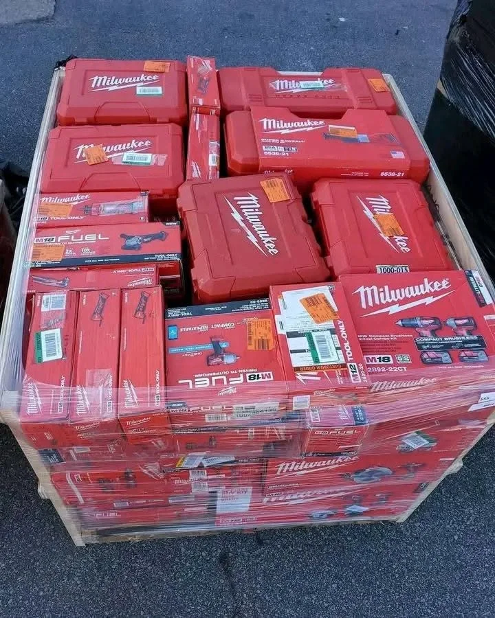 Milwaukee tool pallet featuring assorted cordless drills, impact drivers, saws, and power tools