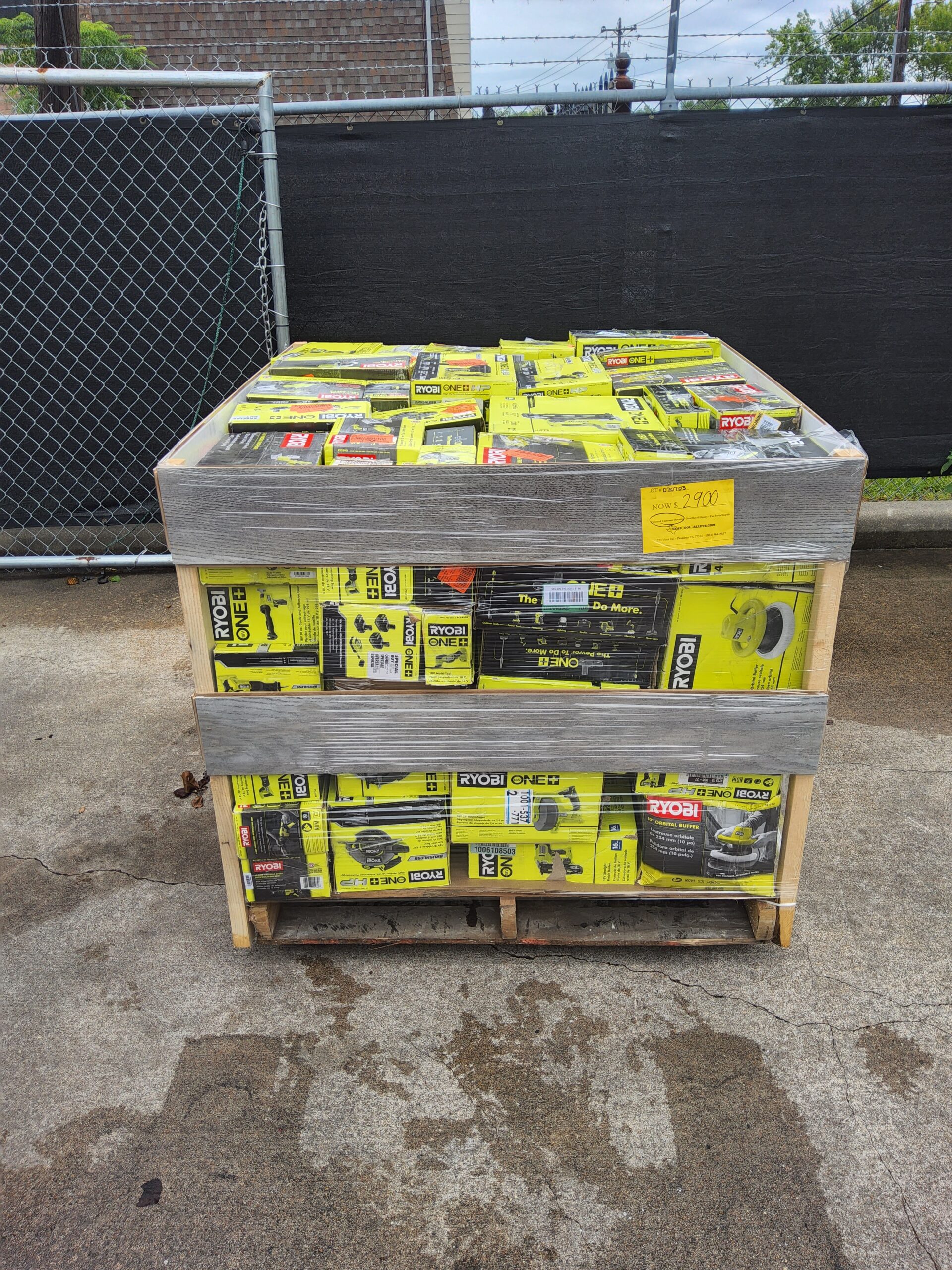 Ryobi tool liquidation pallet with assorted cordless drills, impact drivers, saws, batteries, chargers, and power tool accessories