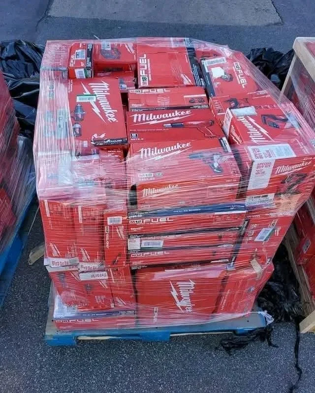 Milwaukee tool pallet featuring assorted cordless drills, impact drivers, saws, and power tools